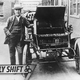 American inventor and physicist Thomas Edison (1847 - 1931) with his first electric car, the Edison Baker. He is holding one of the batteries used to power the vehicle. (Photo by General Photographic Agency/Getty Images)